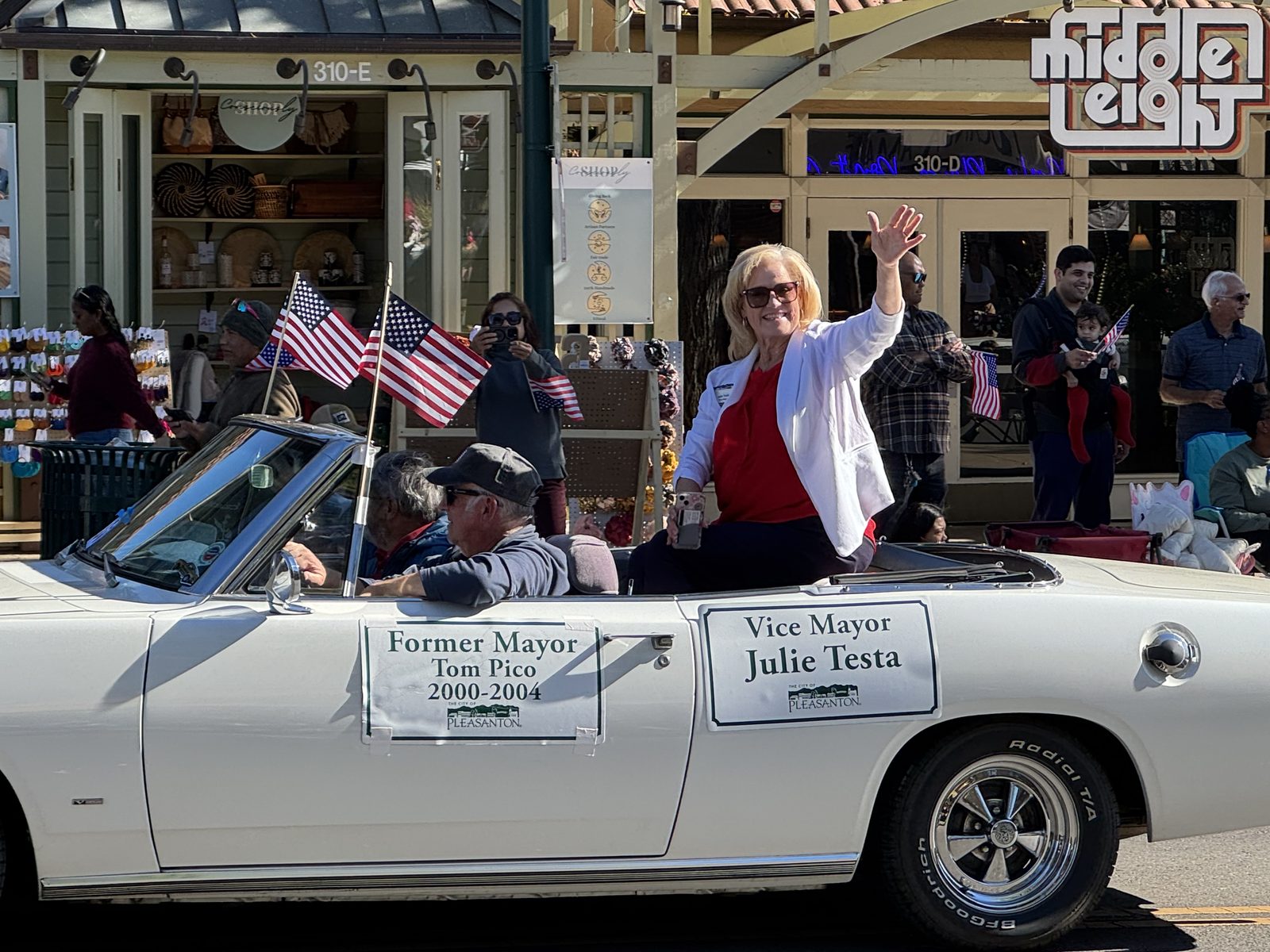 Julie Testa waving to the crowd from a car in a downtown Pleasanton parade
